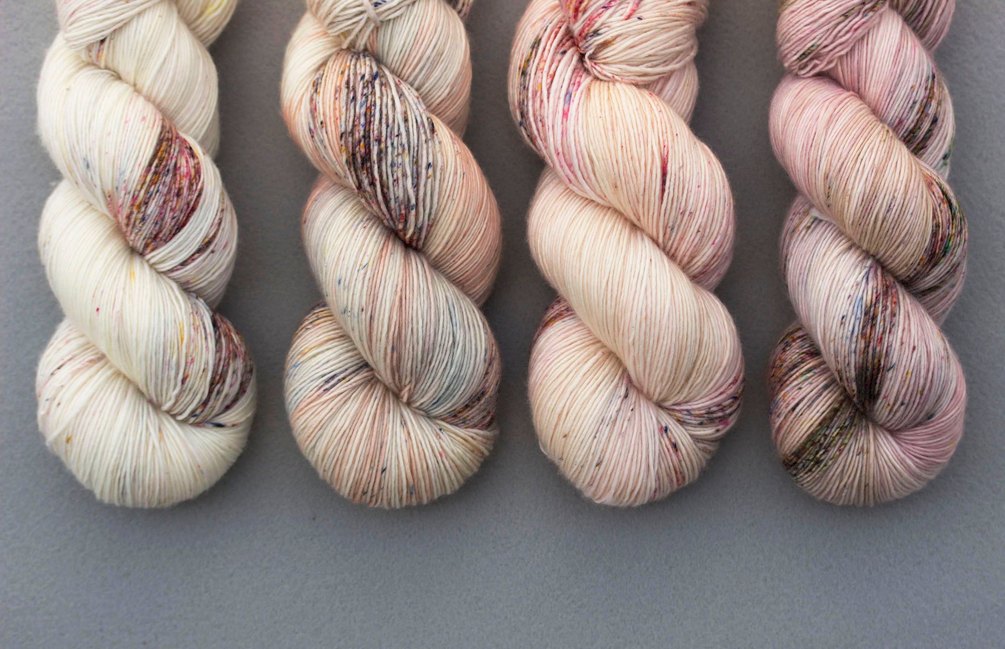 Close-up of hand-dyed speckled yarn skeins